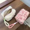 Zoom sur la fermeture éclair robuste et la poignée intégrée de la trousse rose